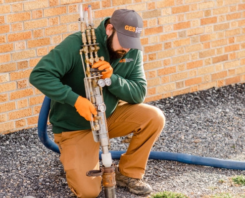 Technician putting foam in place for a tank abandonment at a home